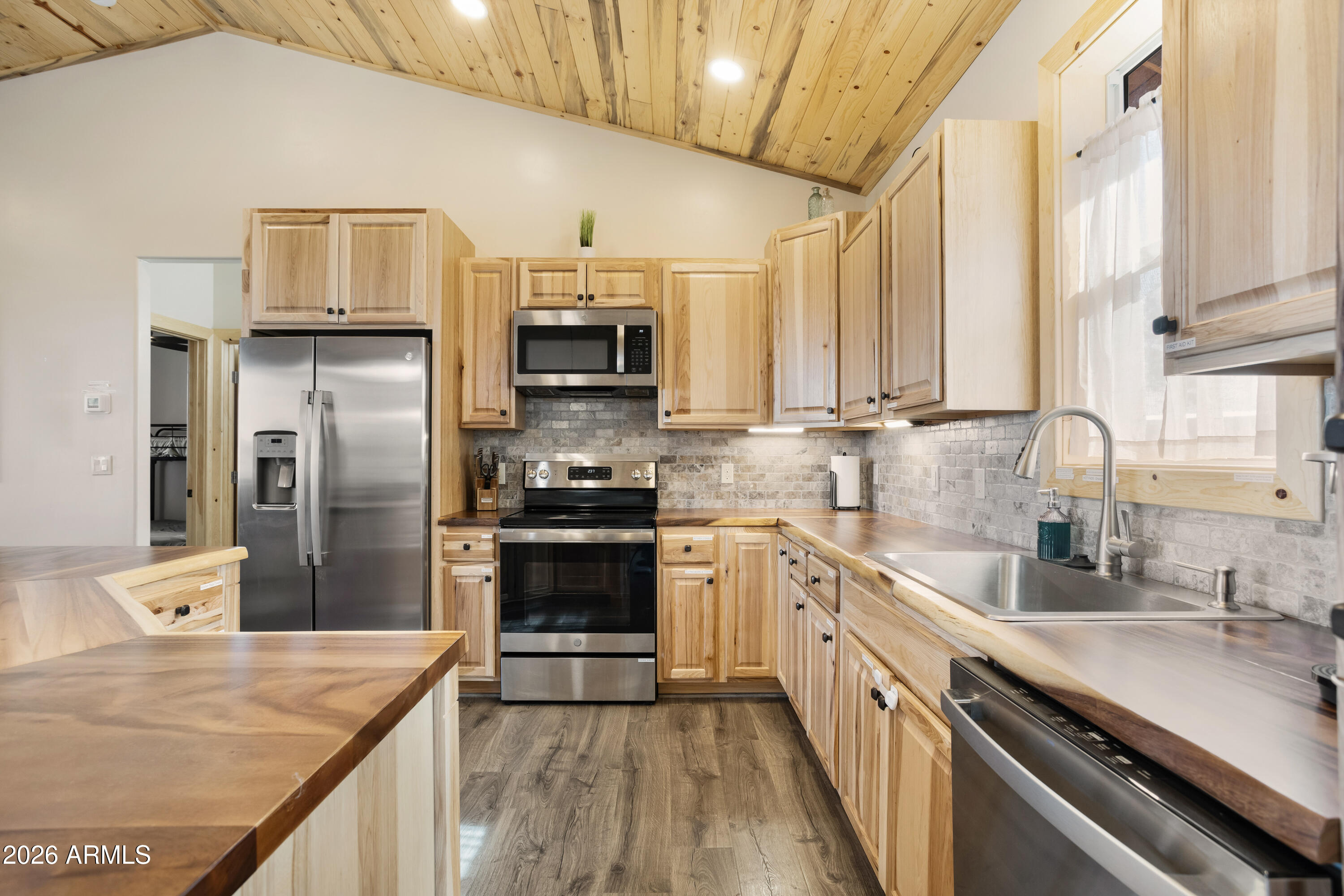 2718 Church Lane Overgaard, AZ 85933 - Photo 15 of 51 a kitchen with stainless steel appliances a sink stove refrigerator and cabinets