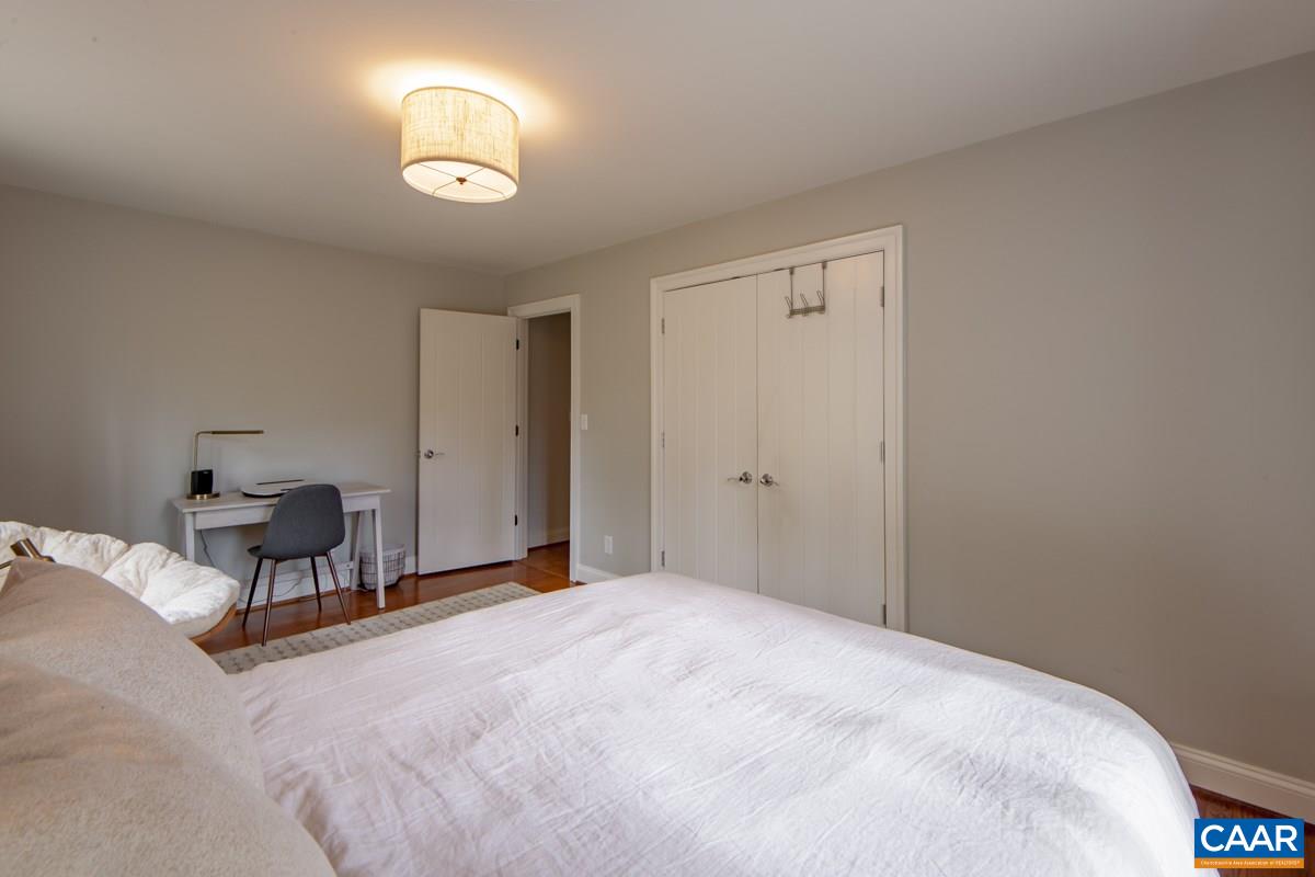 756 Broomley Road Charlottesville, VA 22901 - Photo 41 of 48 a bedroom with a bed and a lamp