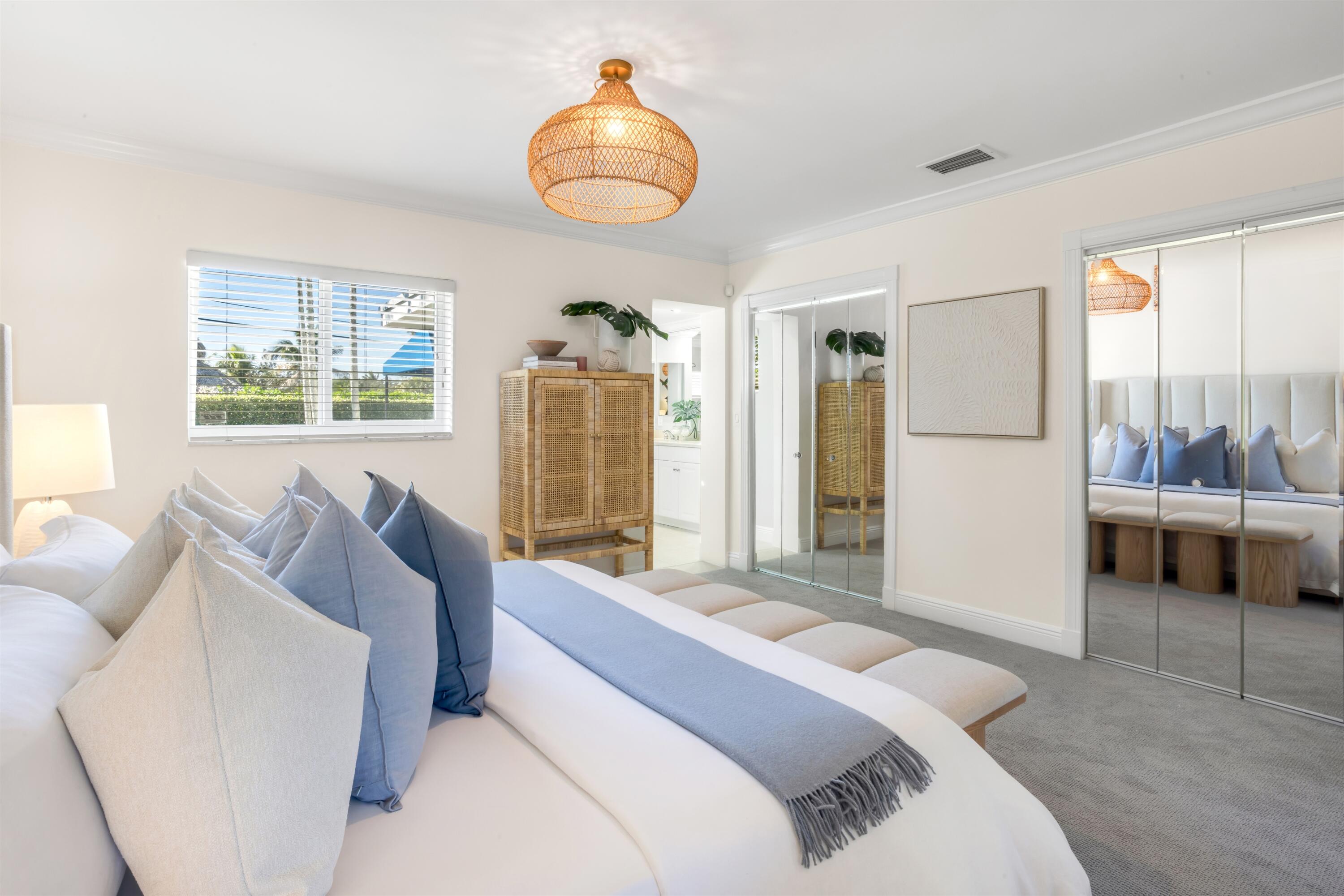 481 Northwest 5th Avenue Boca Raton, FL 33432 - Photo 18 of 28 a bedroom with a bed and a chandelier