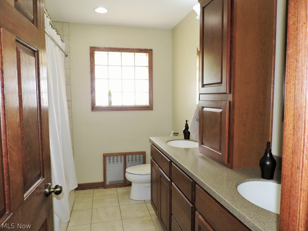 Full bath with dual sinks and lots of cupboard space