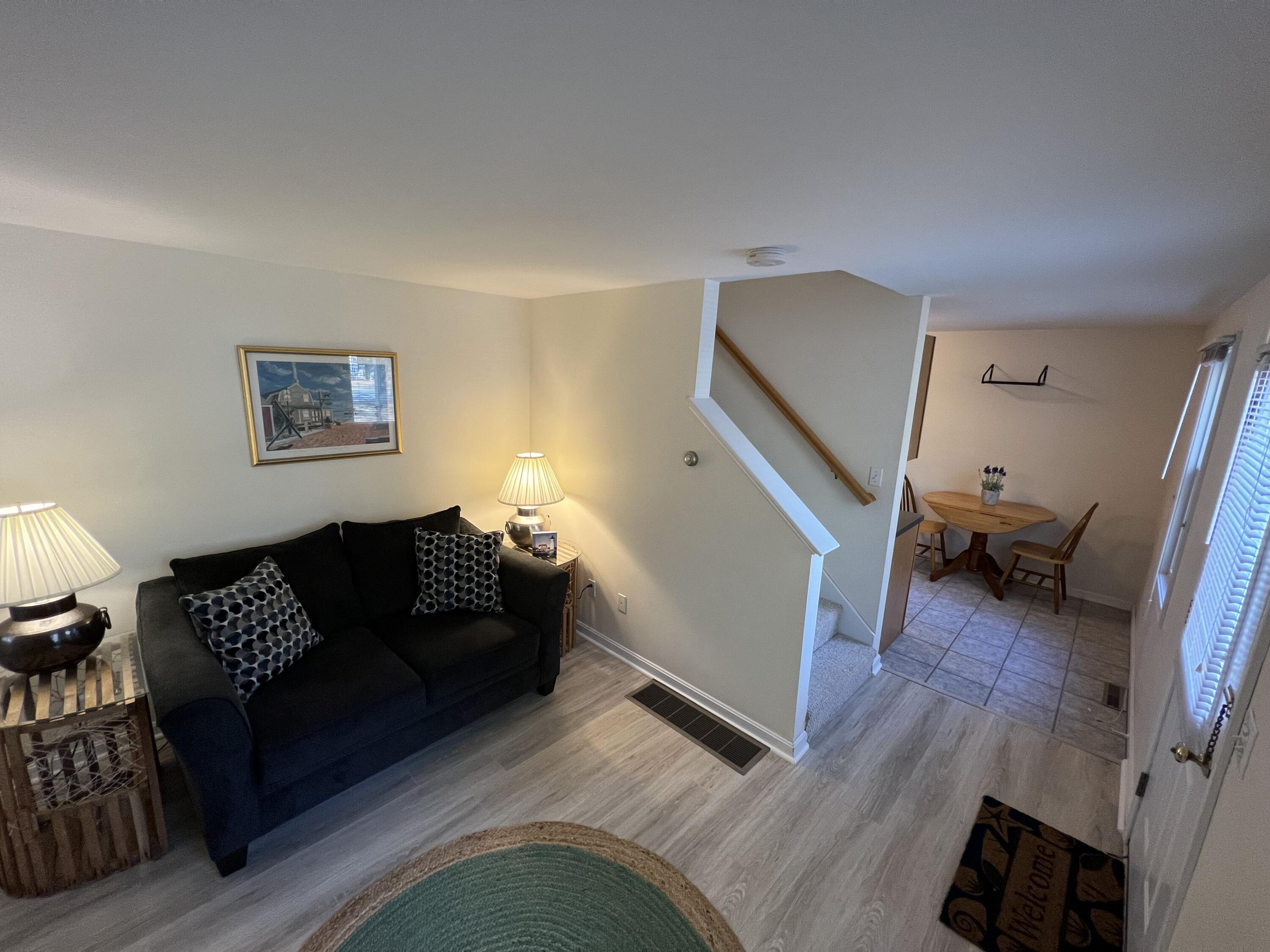 110 Degrass Road Mashpee, MA 02649 - Photo 13 of 46 a living room with furniture and a wooden floor