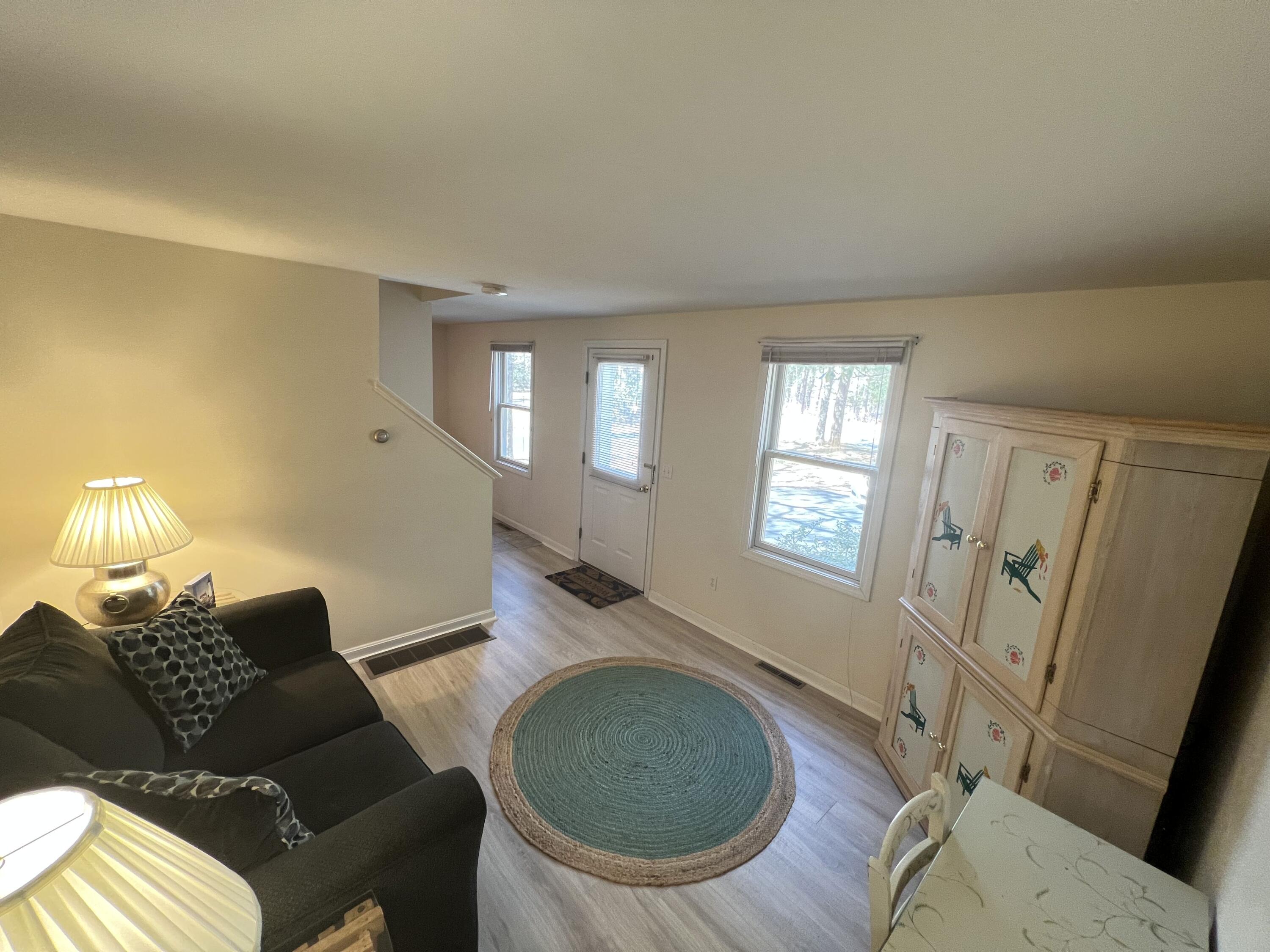 110 Degrass Road Mashpee, MA 02649 - Photo 14 of 46 a living room with furniture and a wooden floor