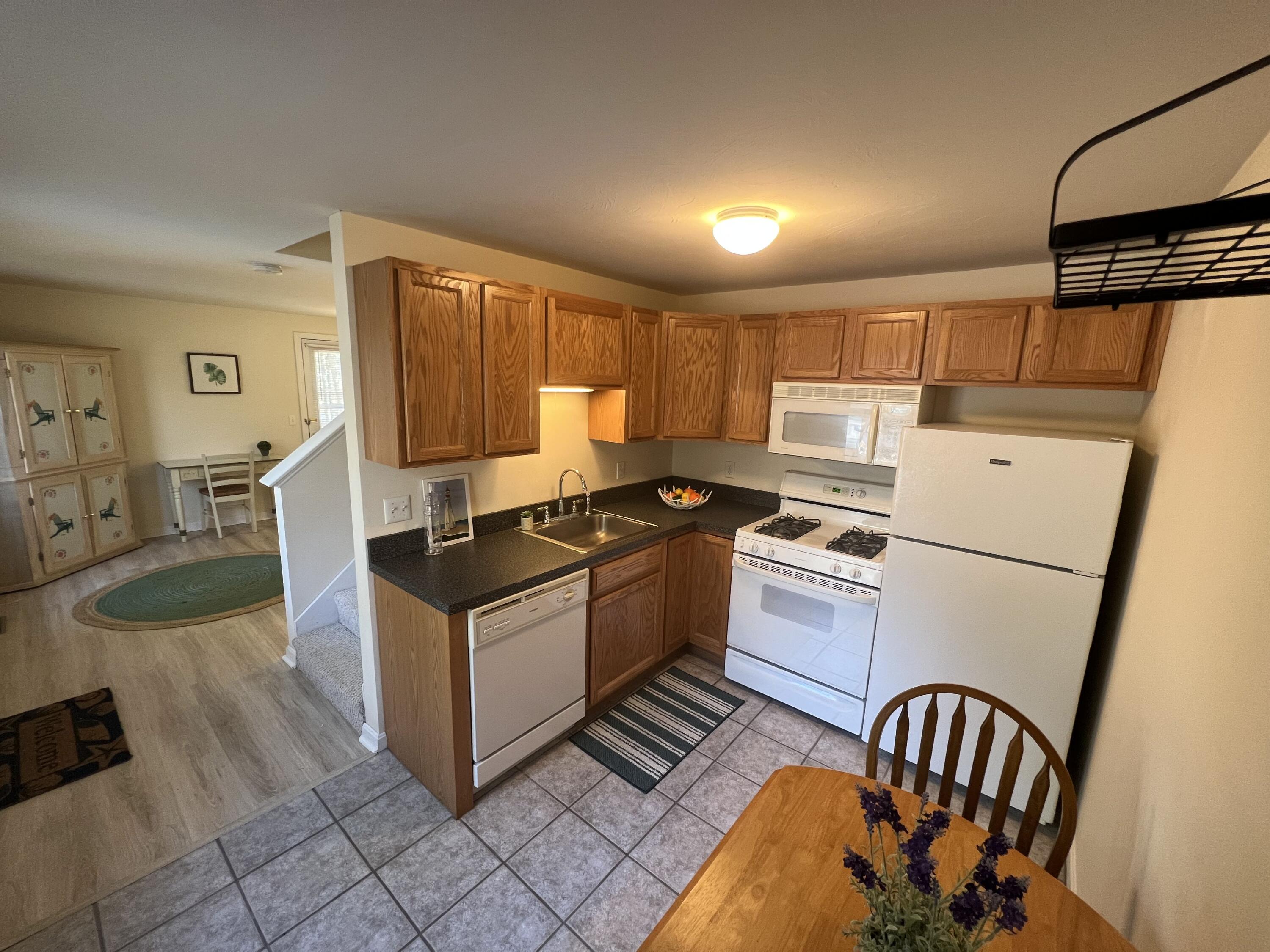 110 Degrass Road Mashpee, MA 02649 - Photo 16 of 46 a kitchen with granite countertop a stove and a refrigerator
