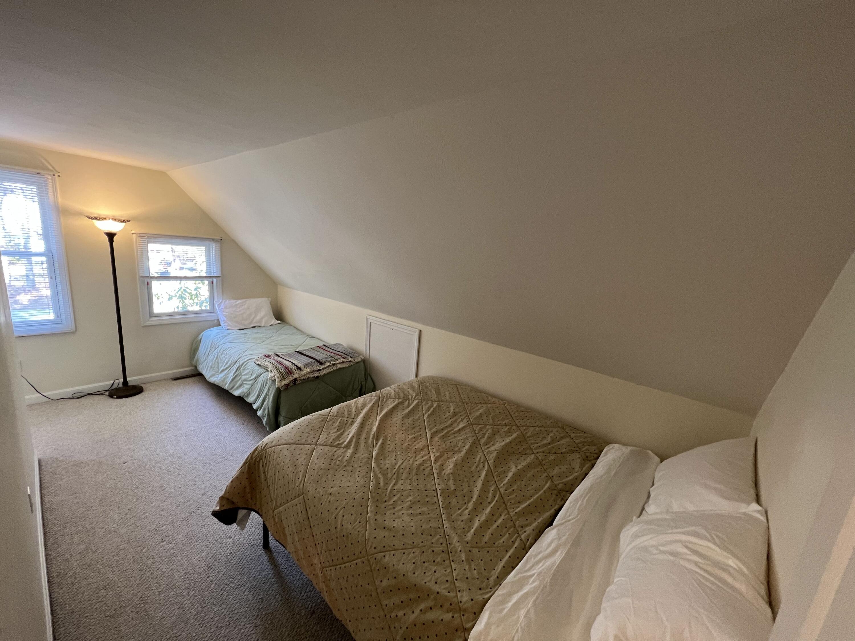 110 Degrass Road Mashpee, MA 02649 - Photo 22 of 46 a bedroom with two beds and painting on the wall