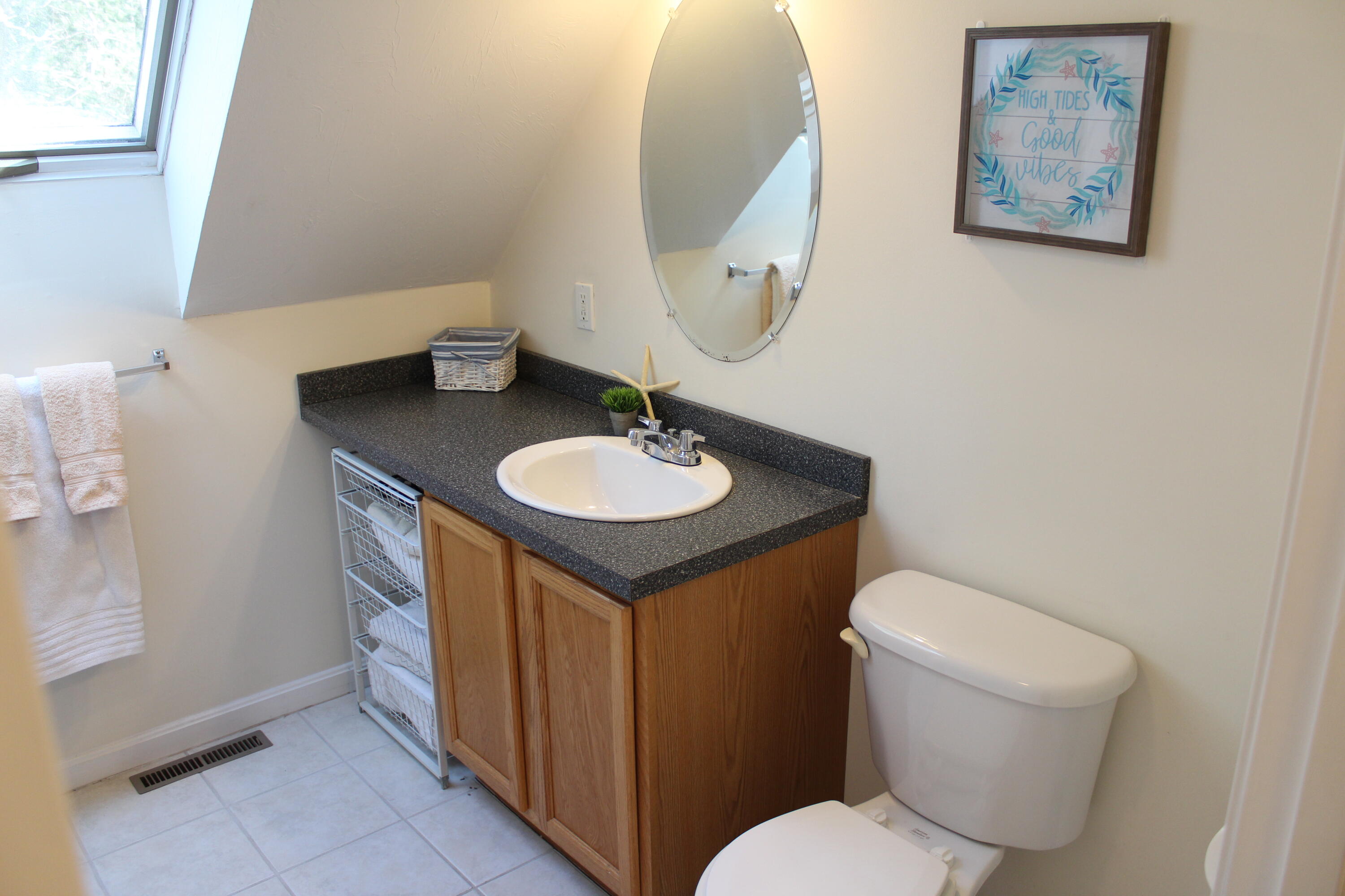 110 Degrass Road Mashpee, MA 02649 - Photo 26 of 46 a bathroom with a toilet sink and mirror