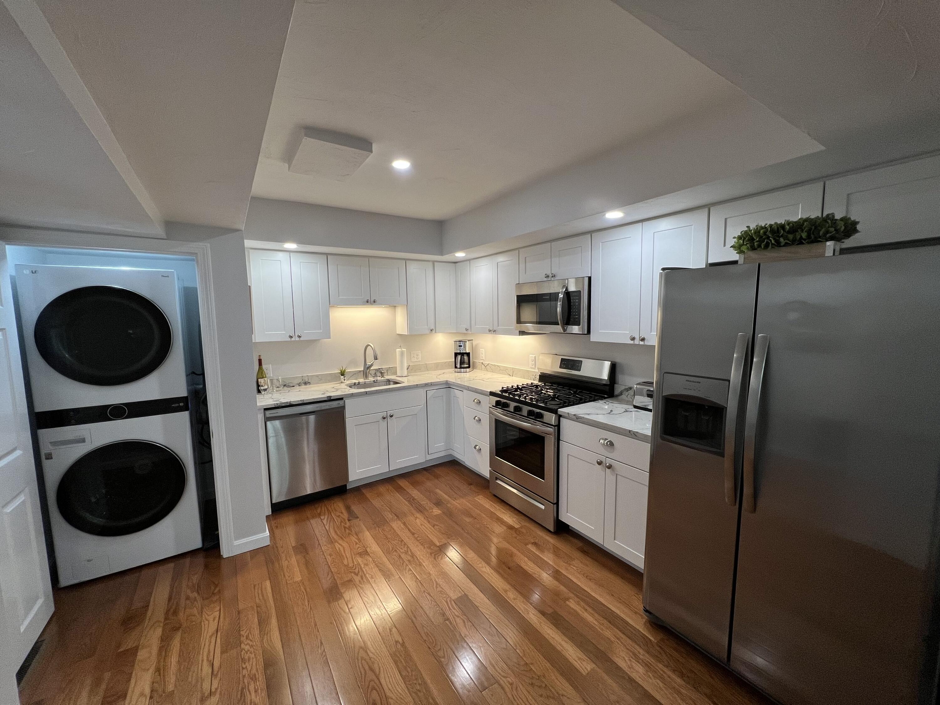 110 Degrass Road Mashpee, MA 02649 - Photo 30 of 46 a kitchen with a refrigerator a washer and dryer
