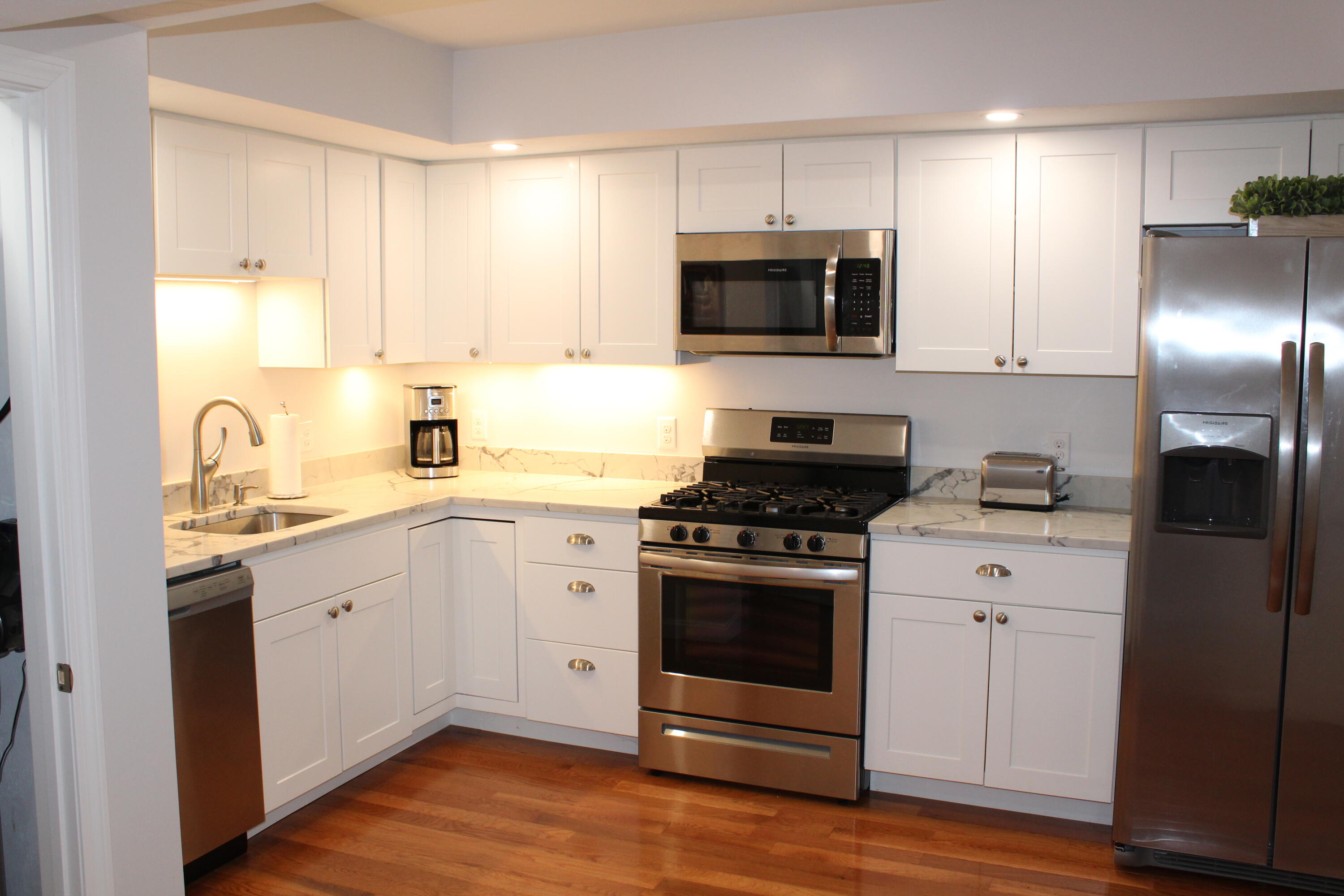 110 Degrass Road Mashpee, MA 02649 - Photo 31 of 46 a kitchen with a sink stove and microwave