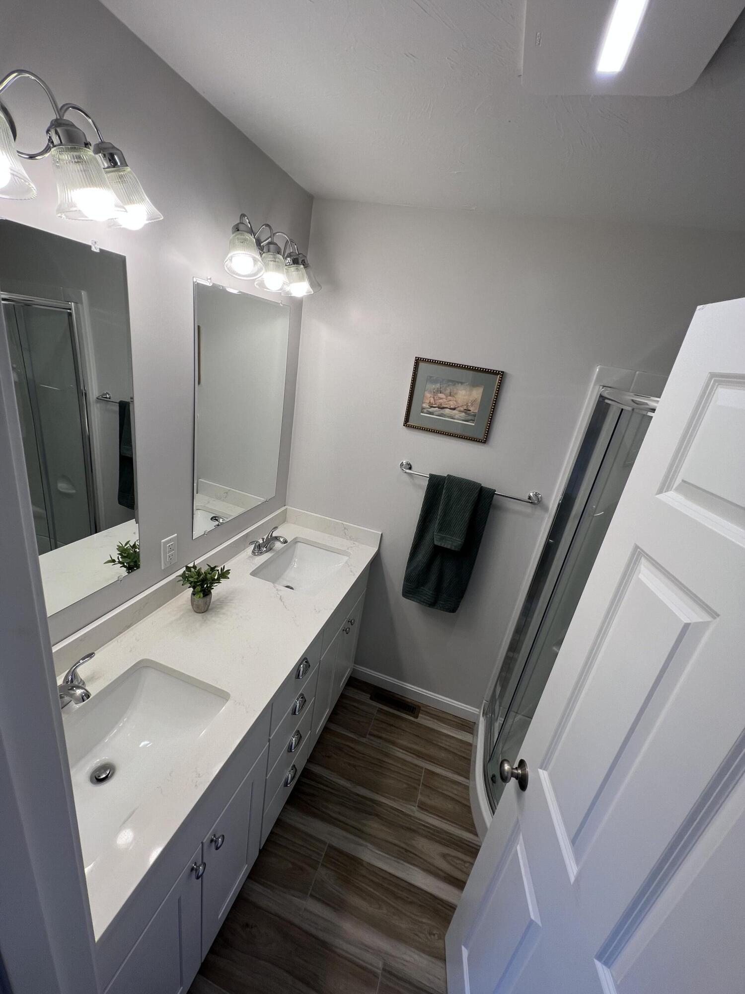 110 Degrass Road Mashpee, MA 02649 - Photo 33 of 46 a en suite bathroom with a double vanity sink and a mirror