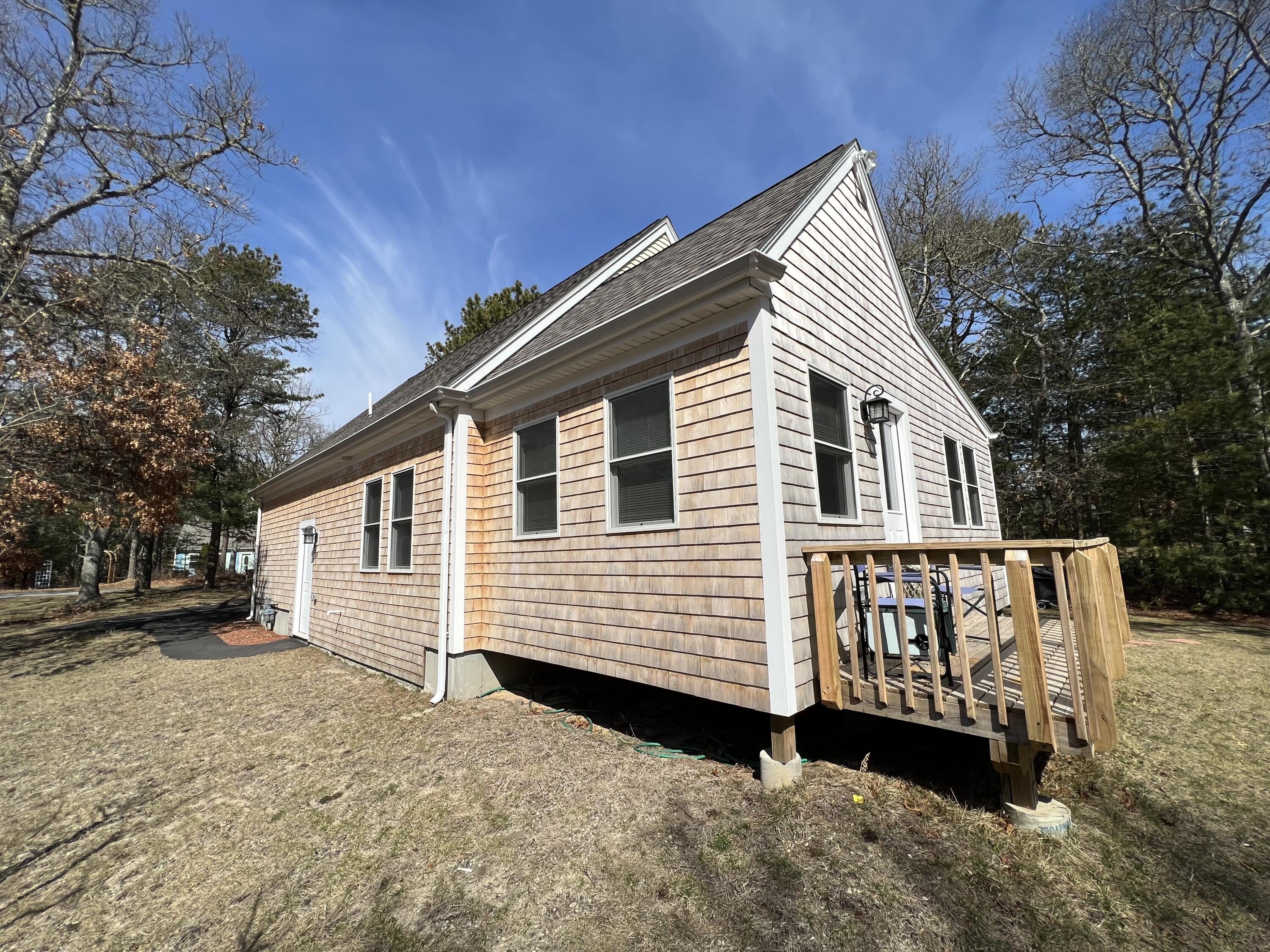 110 Degrass Road Mashpee, MA 02649 - Photo 8 of 46 a view of a house with a yard