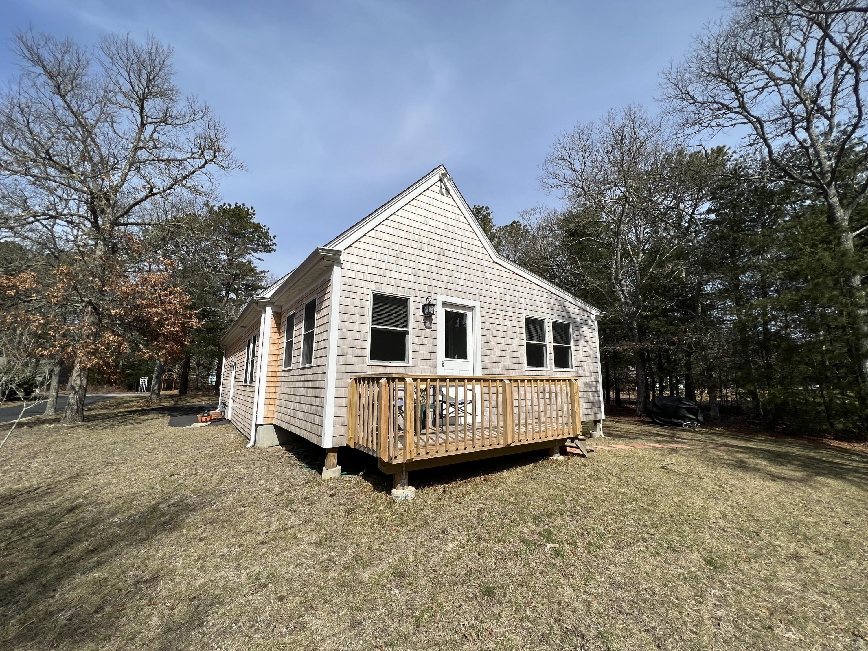 110 Degrass Road Mashpee, MA 02649 - Photo 9 of 46 a view of a house with a yard covered in snow