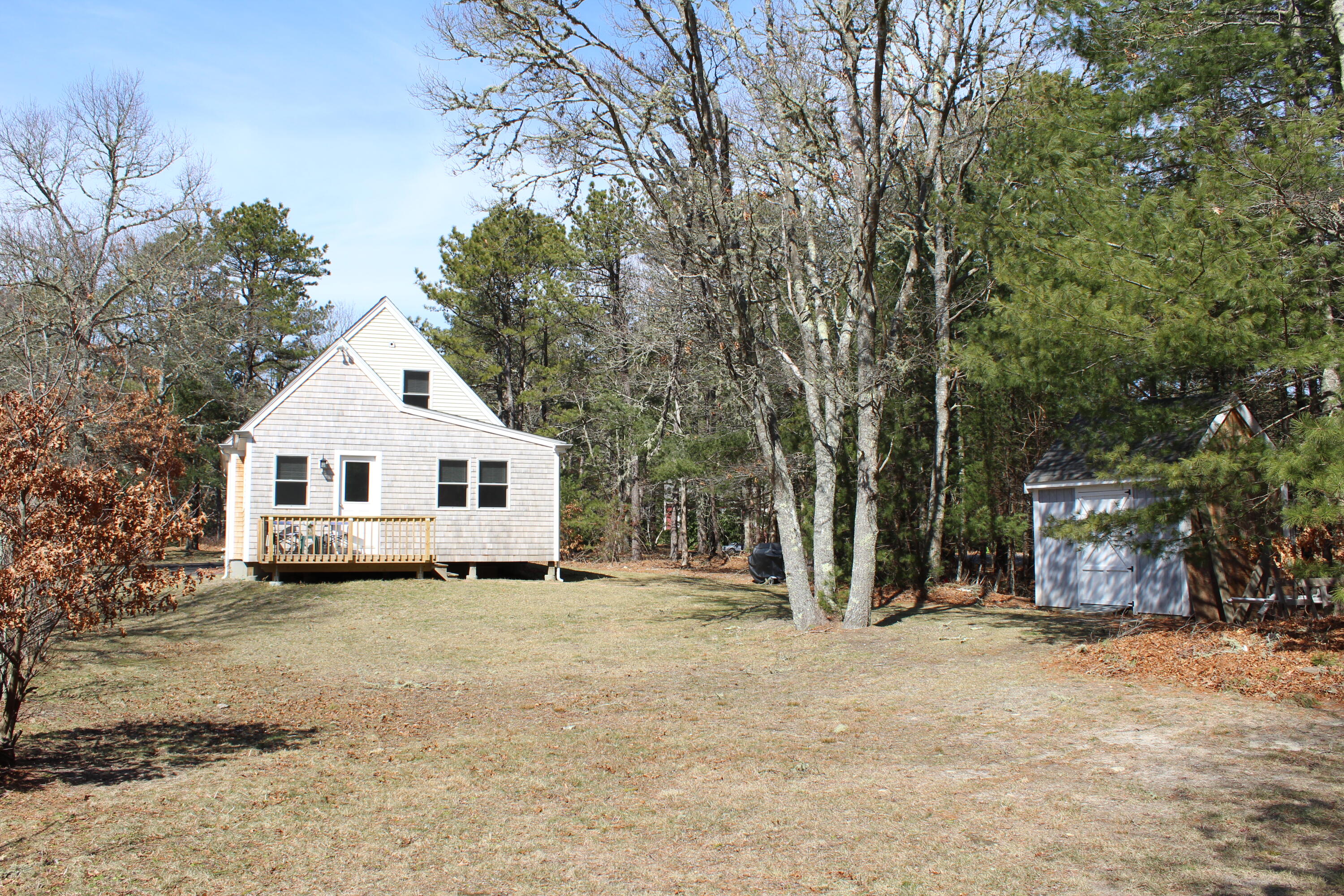 110 Degrass Road Mashpee, MA 02649 - Photo 10 of 46 a view of a house with a yard covered in snow