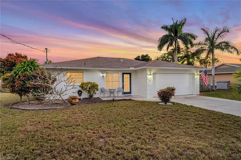 a front view of a house with a garden and porch