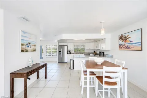 a view of a dining room with furniture and a kitchen