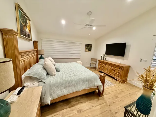 a bedroom with a bed furniture and flat screen tv