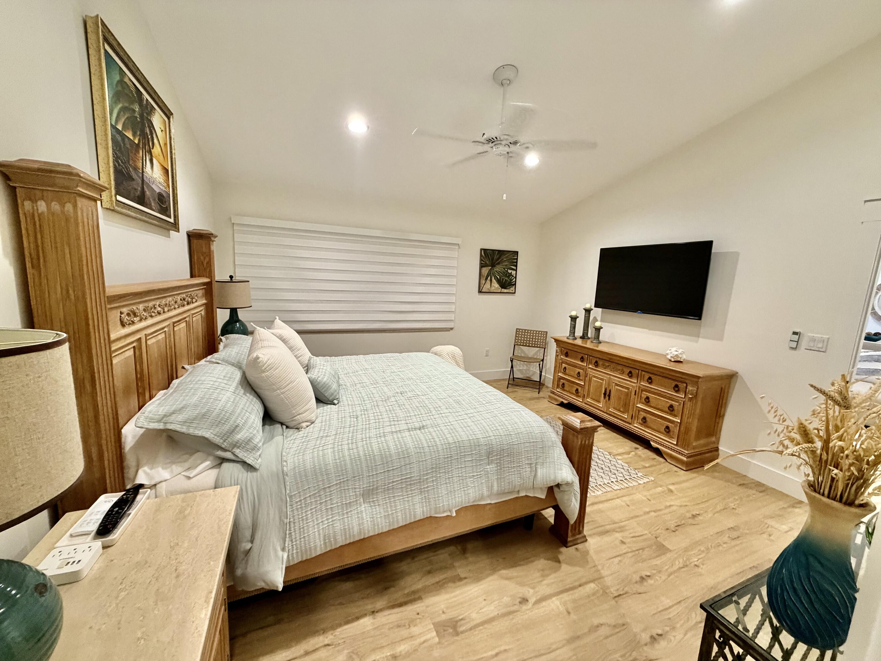 341 Sunset Drive Key Largo, FL 33037 - Photo 13 of 19 a bedroom with a bed furniture and flat screen tv