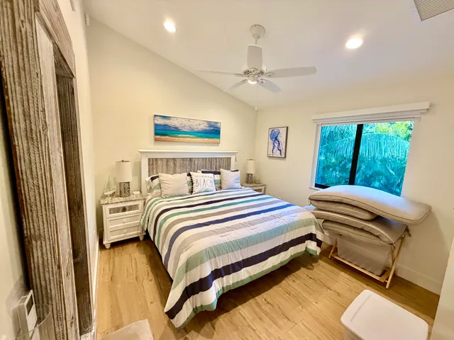 a bedroom with a bed and a large mirror