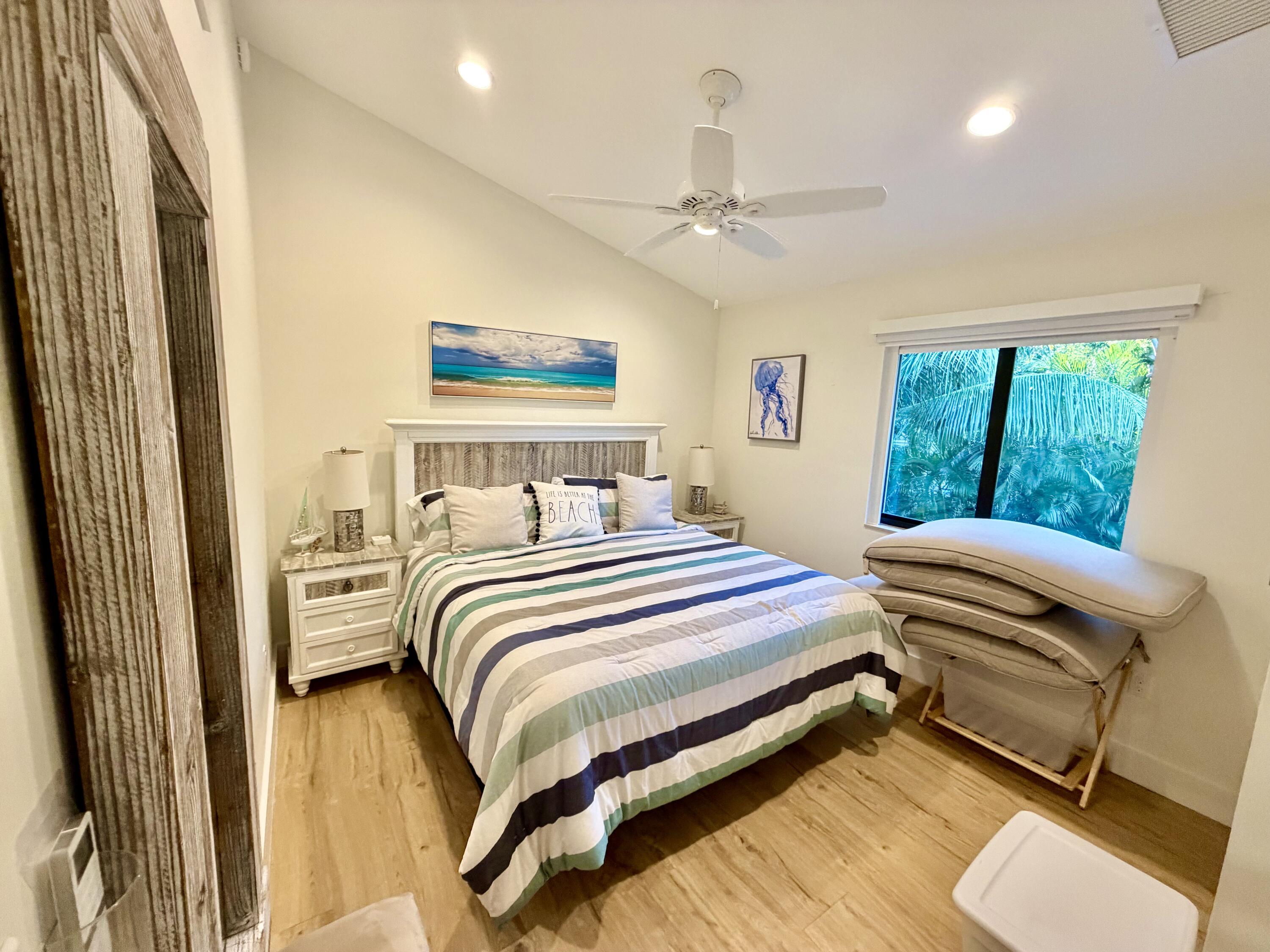 341 Sunset Drive Key Largo, FL 33037 - Photo 14 of 19 a bedroom with a bed and a large mirror