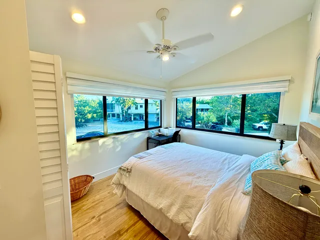 a bed sitting in a bedroom next to a window