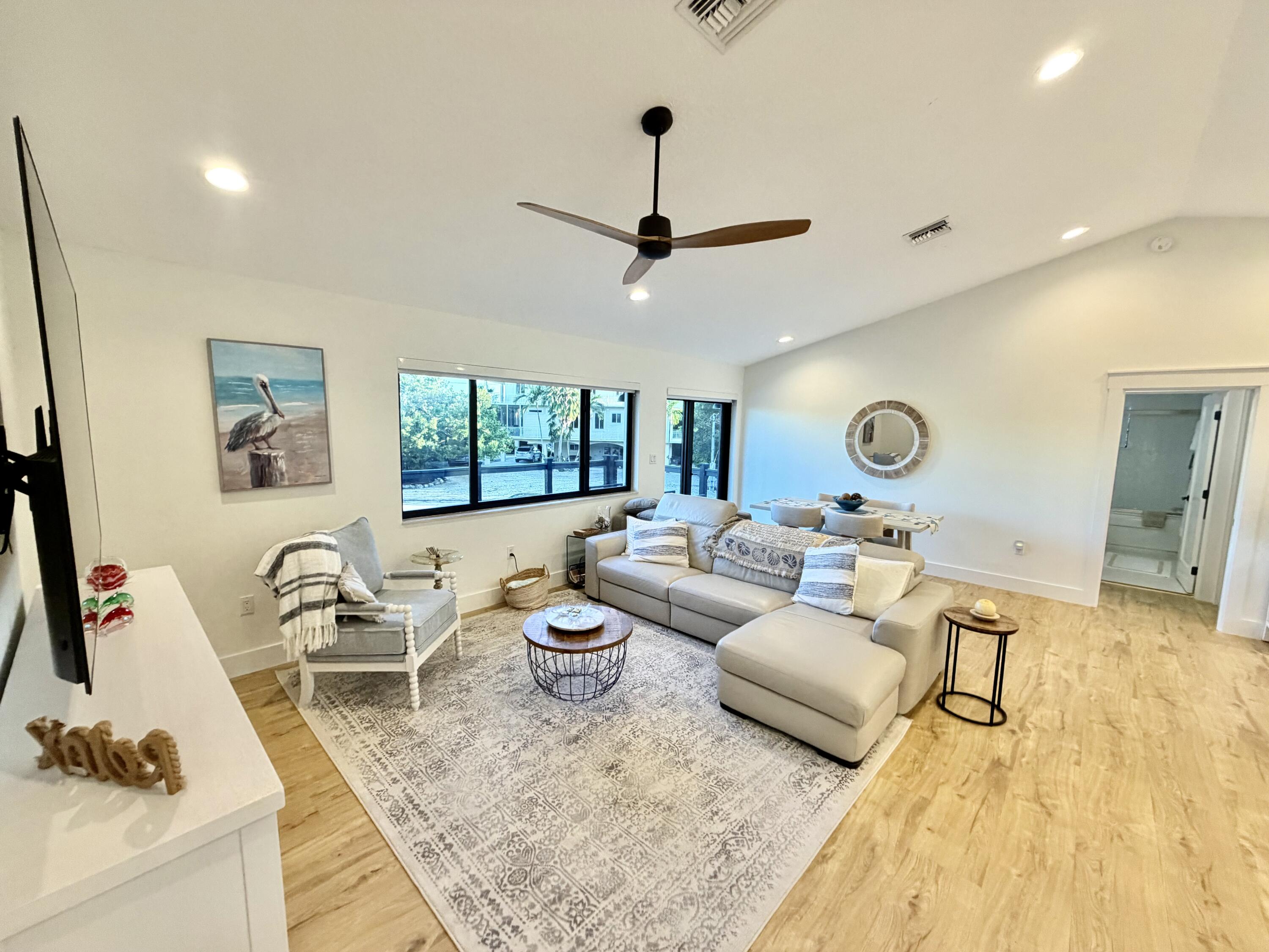 341 Sunset Drive Key Largo, FL 33037 - Photo 17 of 19 a living room with furniture and a flat screen tv