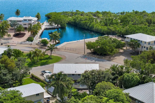 an aerial view of a house with garden space and lake view