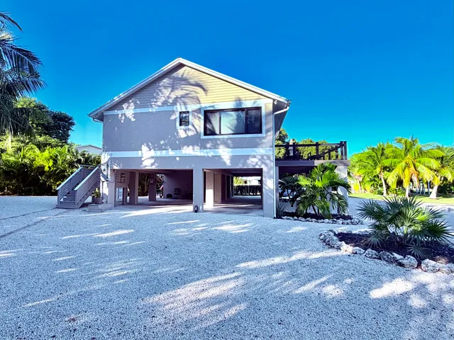 a front view of a house with a yard and a garage