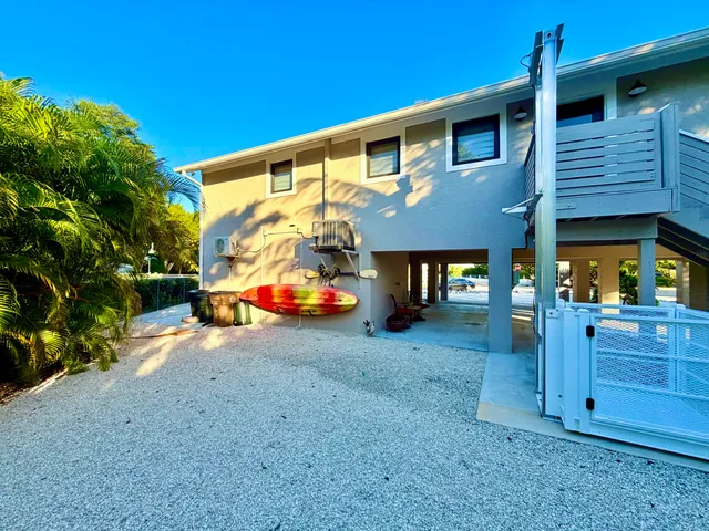 a view of a house with a backyard and sitting area