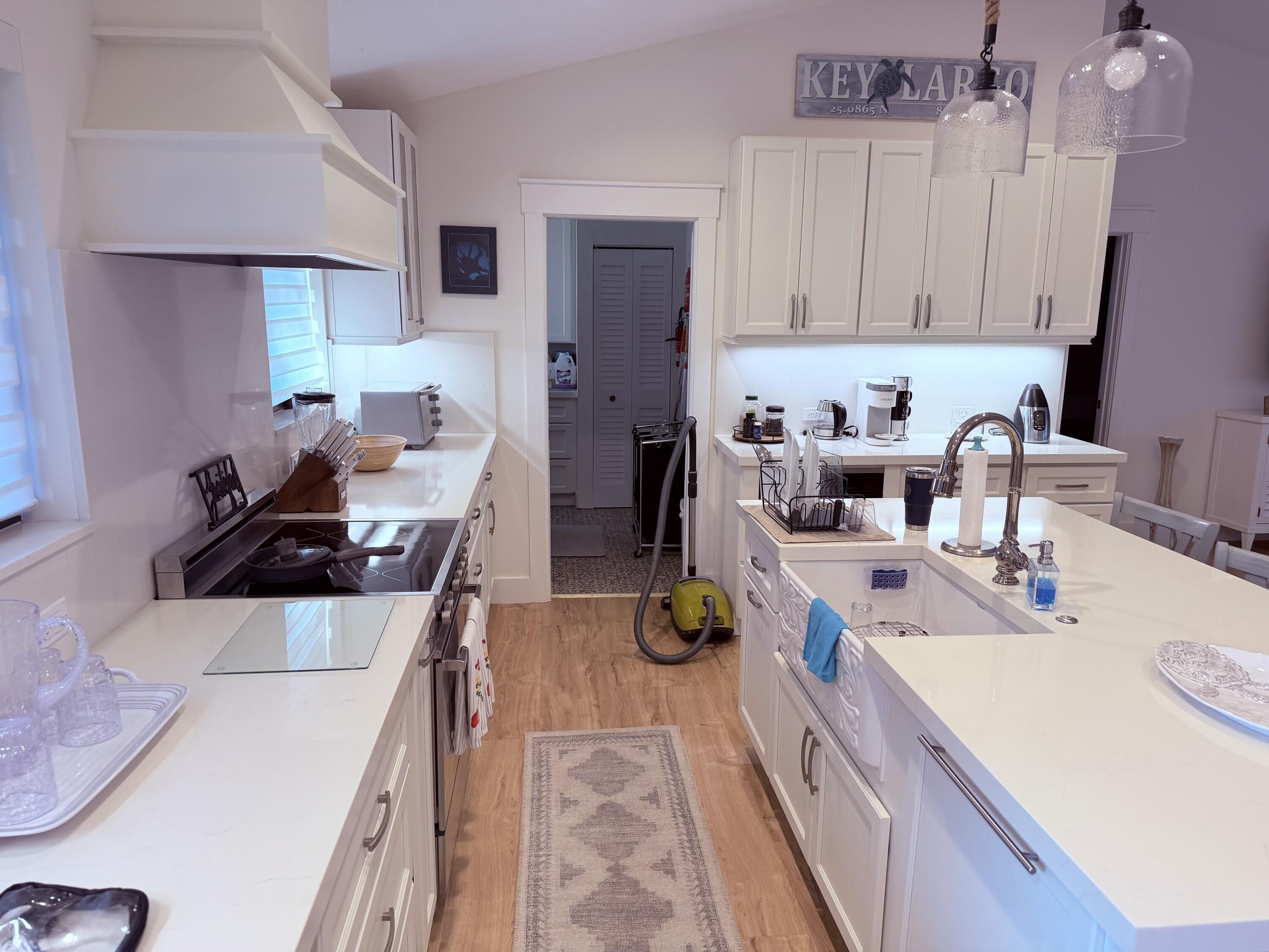 341 Sunset Drive Key Largo, FL 33037 - Photo 10 of 19 a kitchen with a sink stove and cabinets
