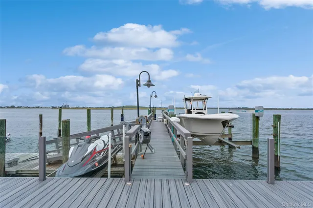 a view of a roof deck with two chair and a table