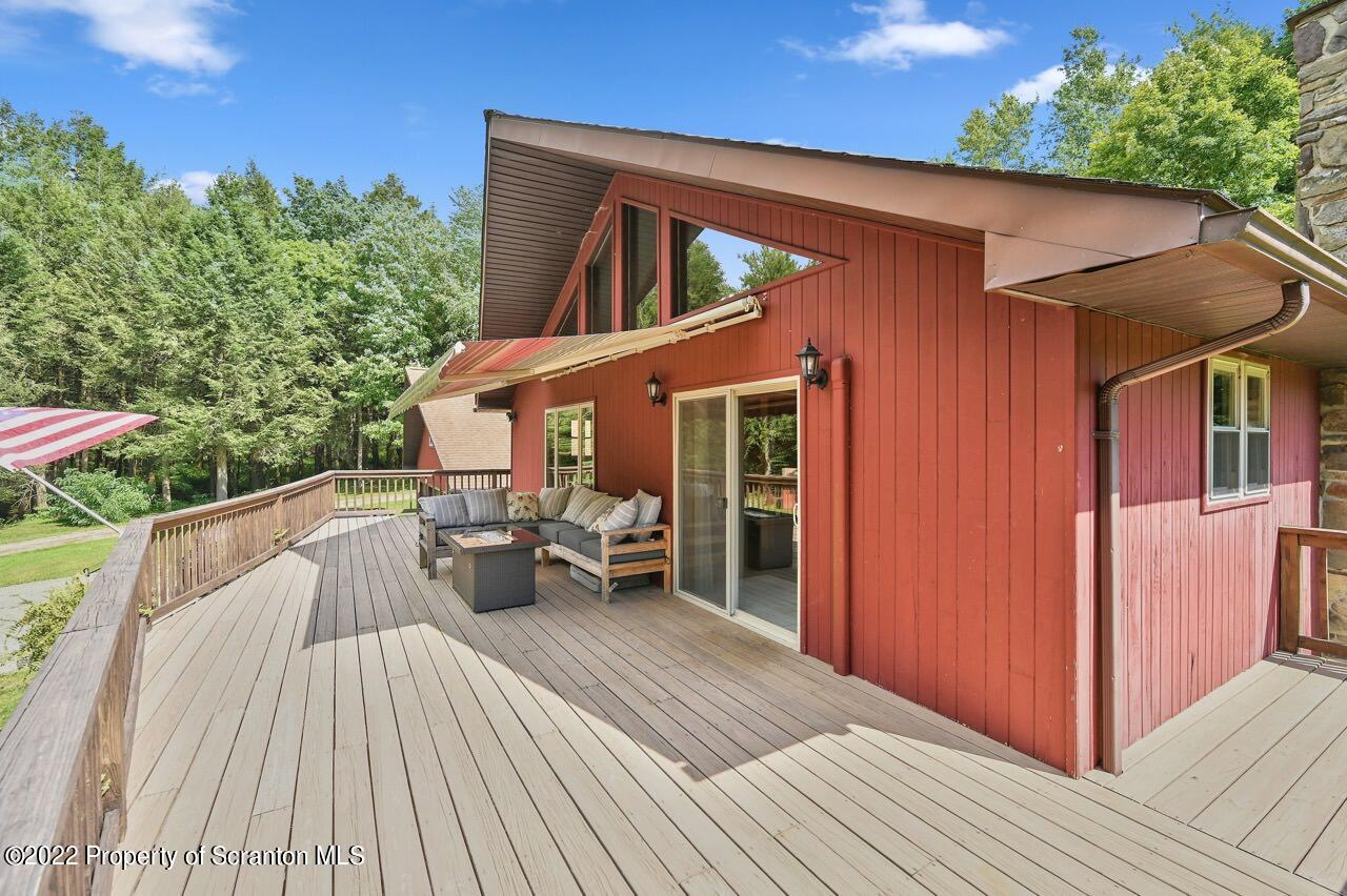 3560 State Rte 2012 Forest City, PA 18421 - Photo 7 of 63 a view of house with deck outdoor seating and yard in back