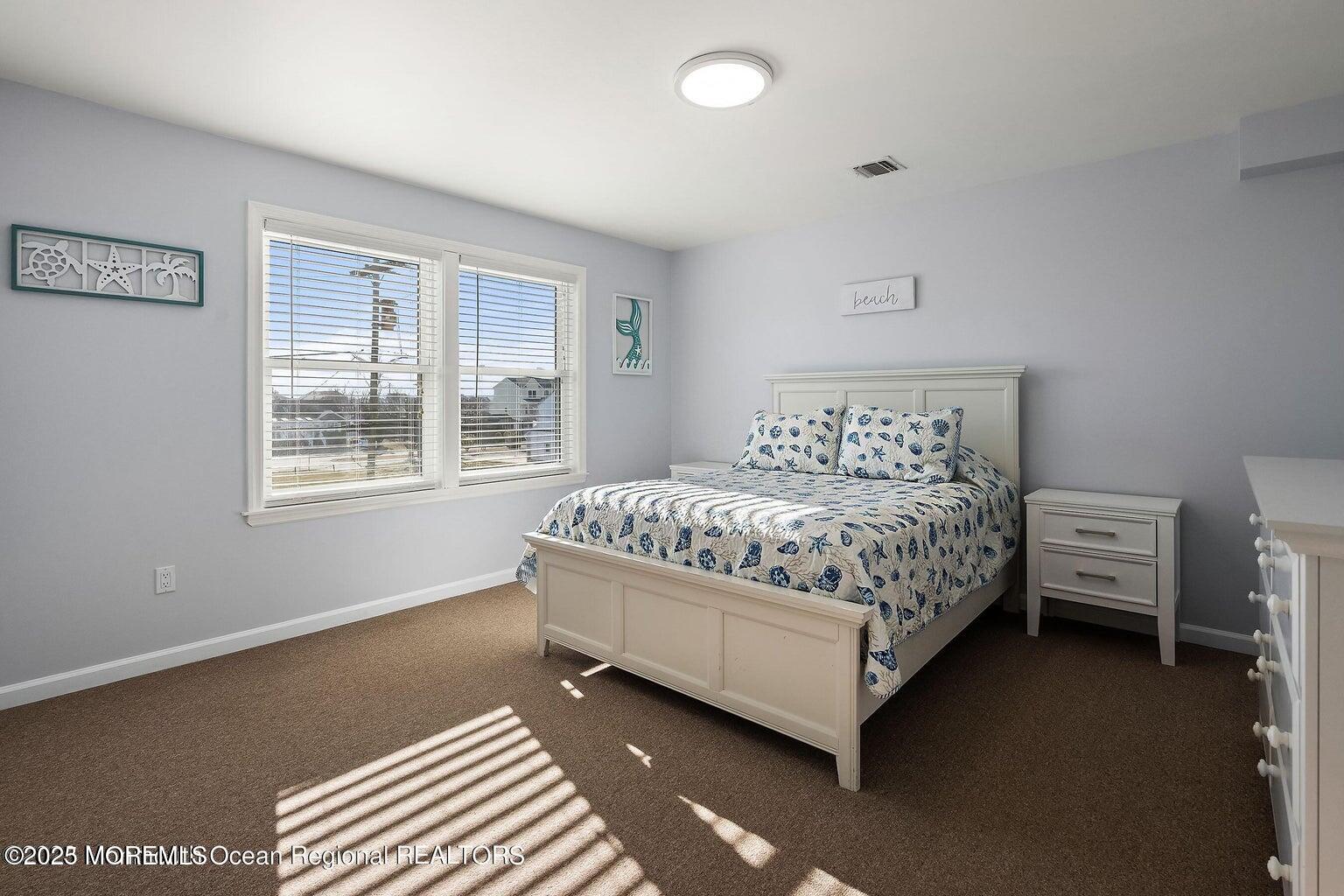 32 Niblick Street Point Pleasant Beach, NJ 08742 - Photo 11 of 31 a bed sitting in a bedroom next to a window