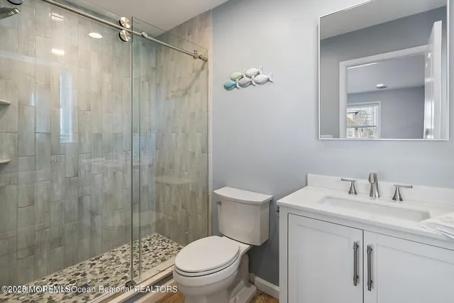 a bathroom with a sink toilet and shower