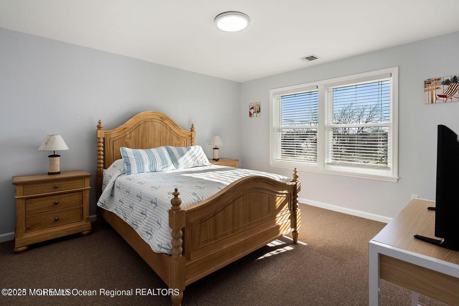 32 Niblick Street Point Pleasant Beach, NJ 08742 - Photo 13 of 31 a bedroom with a bed and a flat screen tv