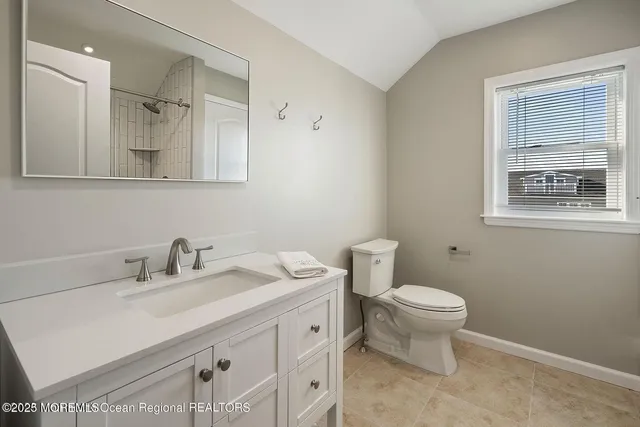 a bathroom with a sink toilet and mirror