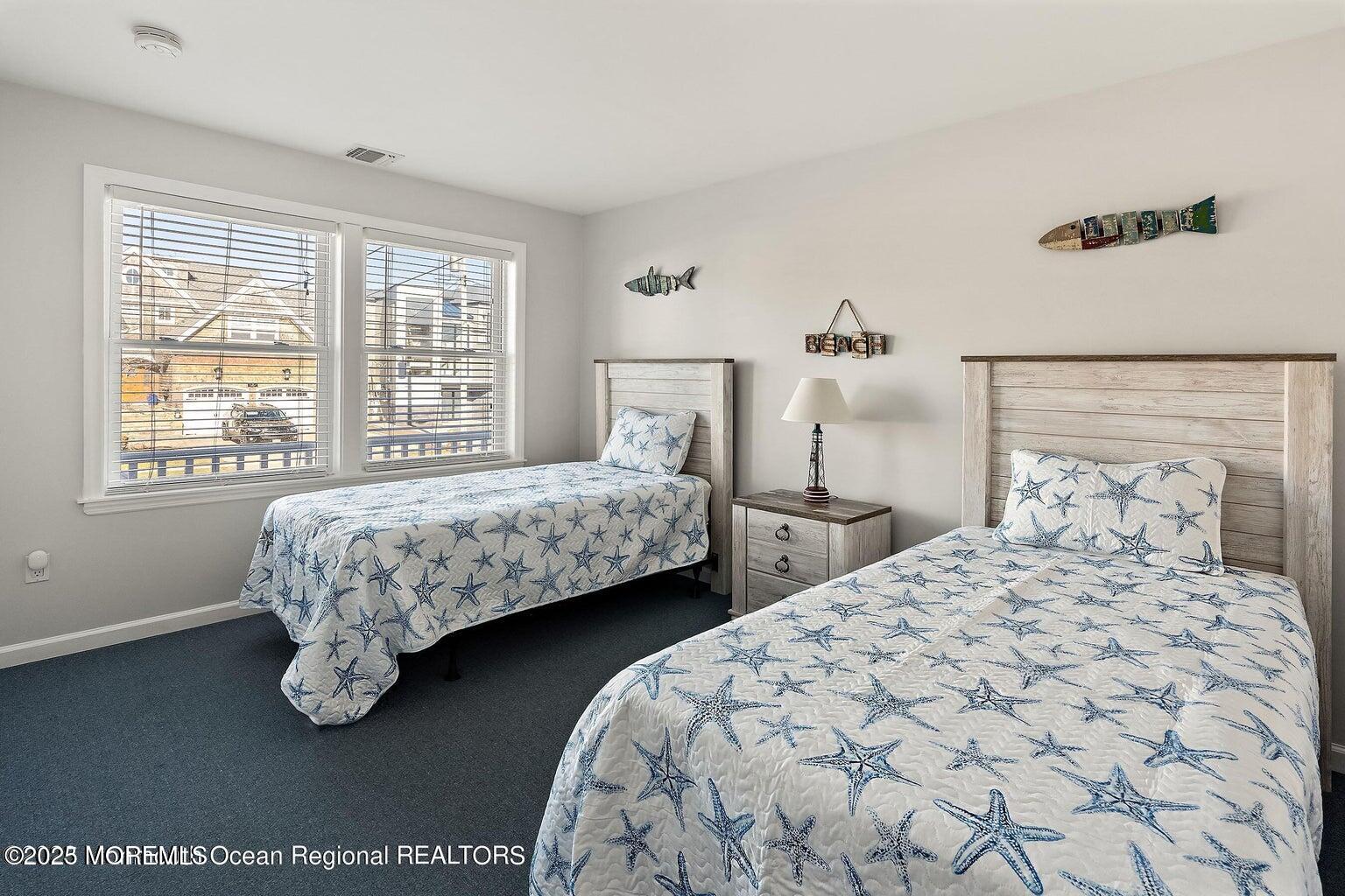 32 Niblick Street Point Pleasant Beach, NJ 08742 - Photo 18 of 31 a bedroom with two beds and a table