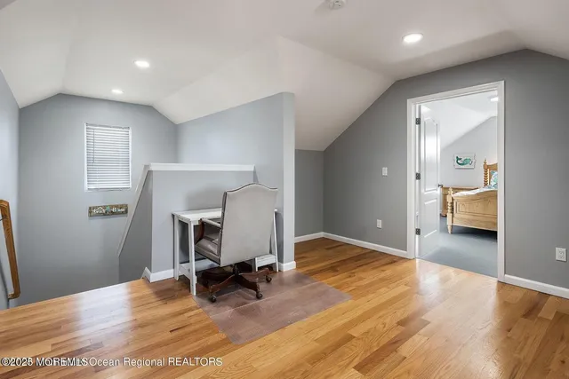 a view of a room with wooden floor and furniture