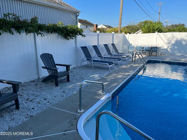 swimming pool view with a seating space