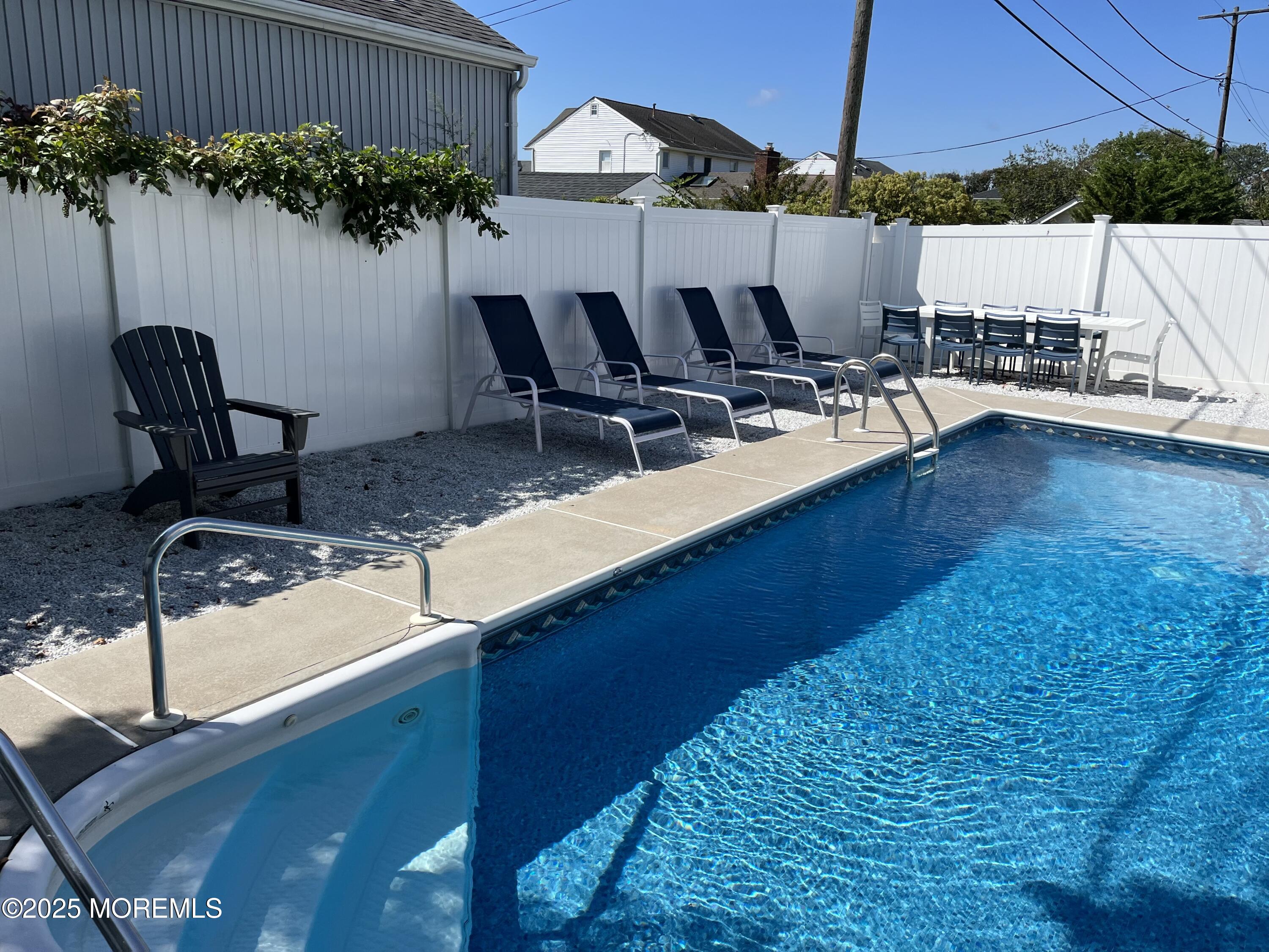32 Niblick Street Point Pleasant Beach, NJ 08742 - Photo 28 of 31 a view of a patio with table and chairs under an umbrella