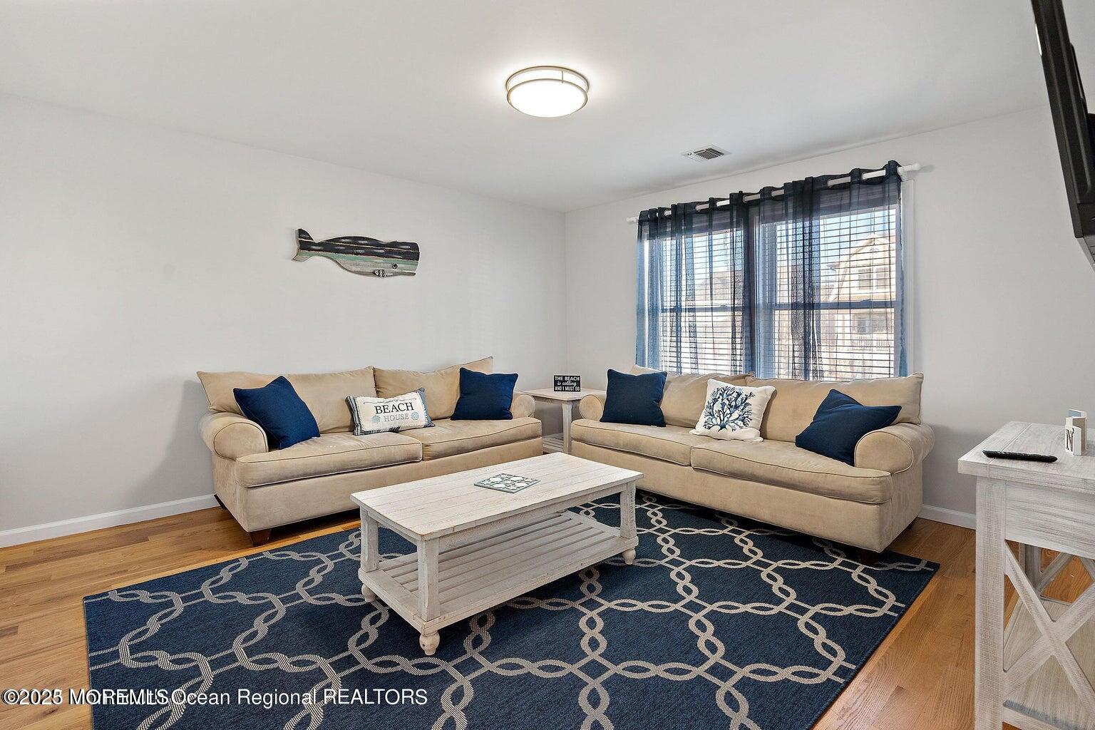 32 Niblick Street Point Pleasant Beach, NJ 08742 - Photo 3 of 31 a living room with a couch and a window