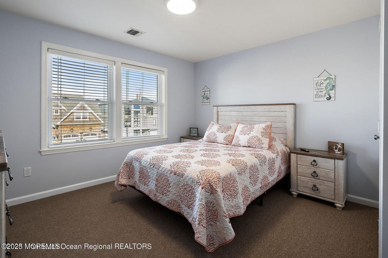 32 Niblick Street Point Pleasant Beach, NJ 08742 - Photo 9 of 31 a bed sitting in a bedroom next to a window