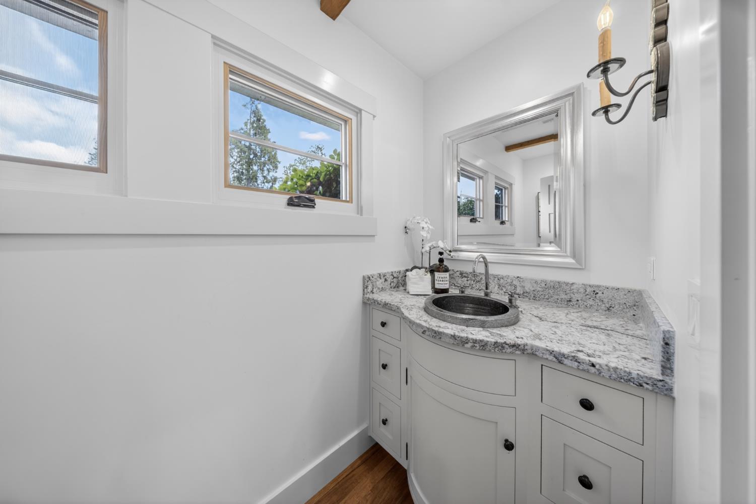 14621 East 8 Mile Road Linden, CA 95236 - Photo 18 of 38 a bathroom with a granite countertop sink and a mirror