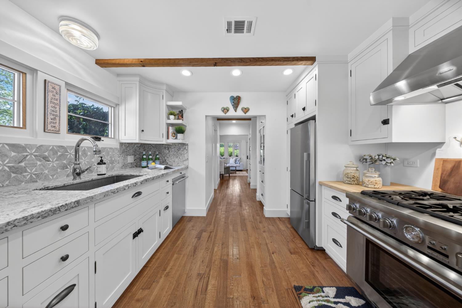 14621 East 8 Mile Road Linden, CA 95236 - Photo 24 of 38 a large kitchen with stainless steel appliances granite countertop a lot of counter space and wooden floors