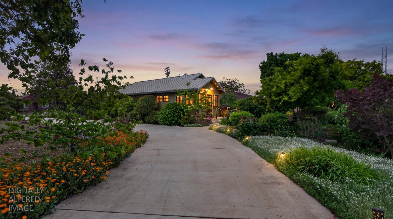 14621 East 8 Mile Road Linden, CA 95236 - Photo 3 of 38 a view of a garden with a building in the background