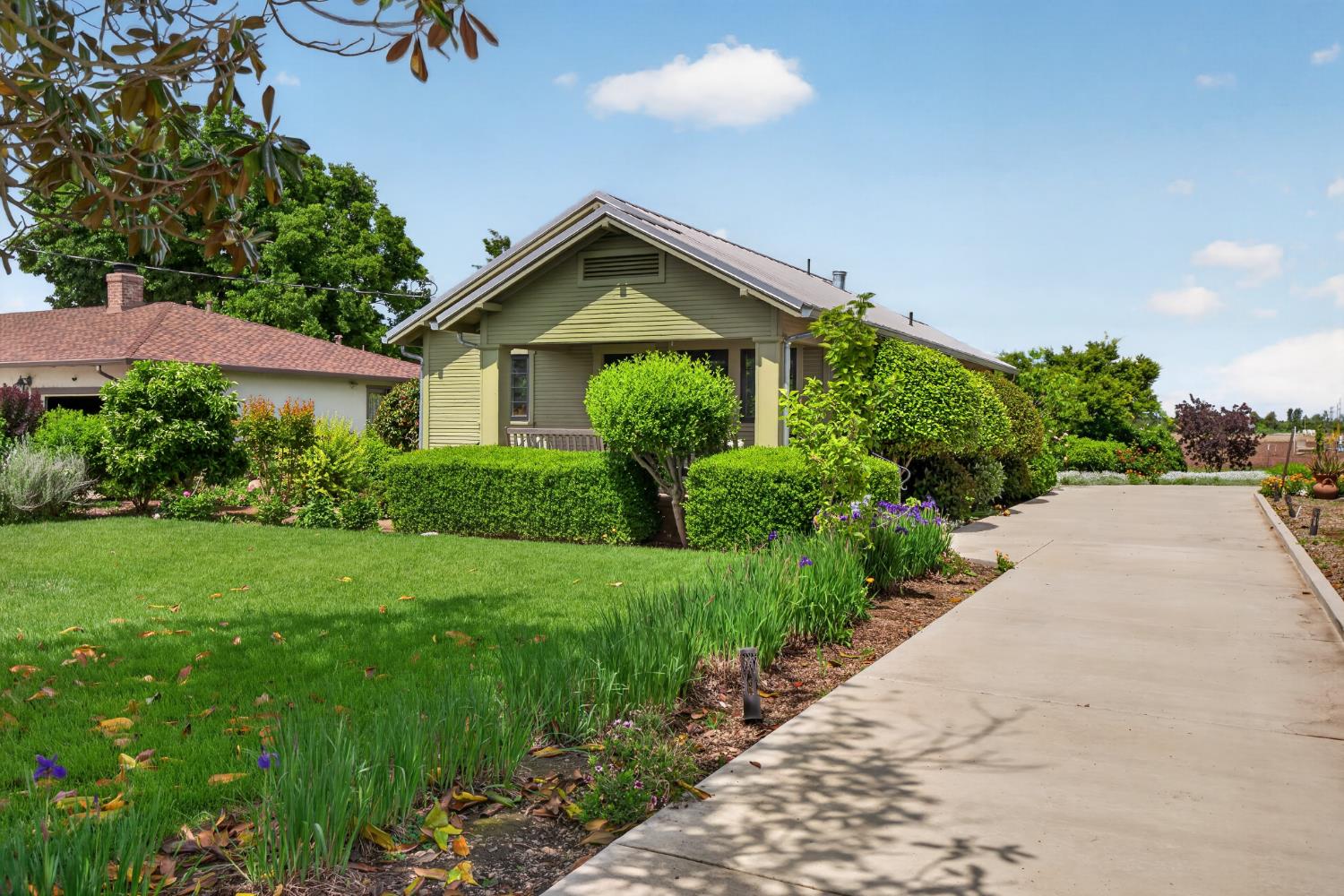 14621 East 8 Mile Road Linden, CA 95236 - Photo 9 of 38 a view of a garden with plants and large trees