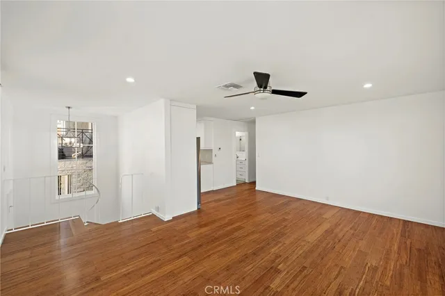 a view of a kitchen with a sink and a refrigerator