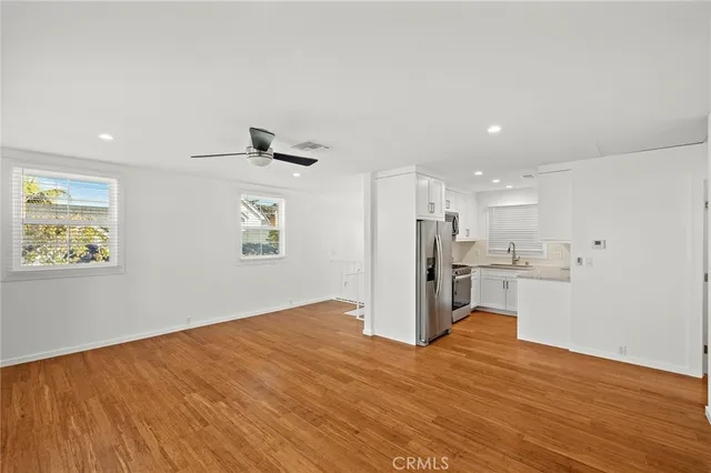 a kitchen with stainless steel appliances granite countertop a refrigerator stove and oven