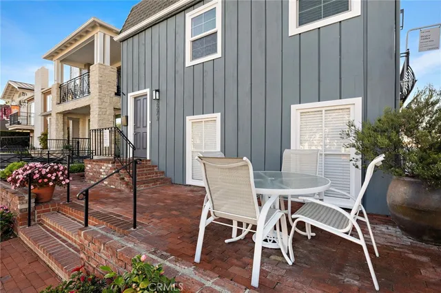 a view of a patio with a table and chairs and potted plants