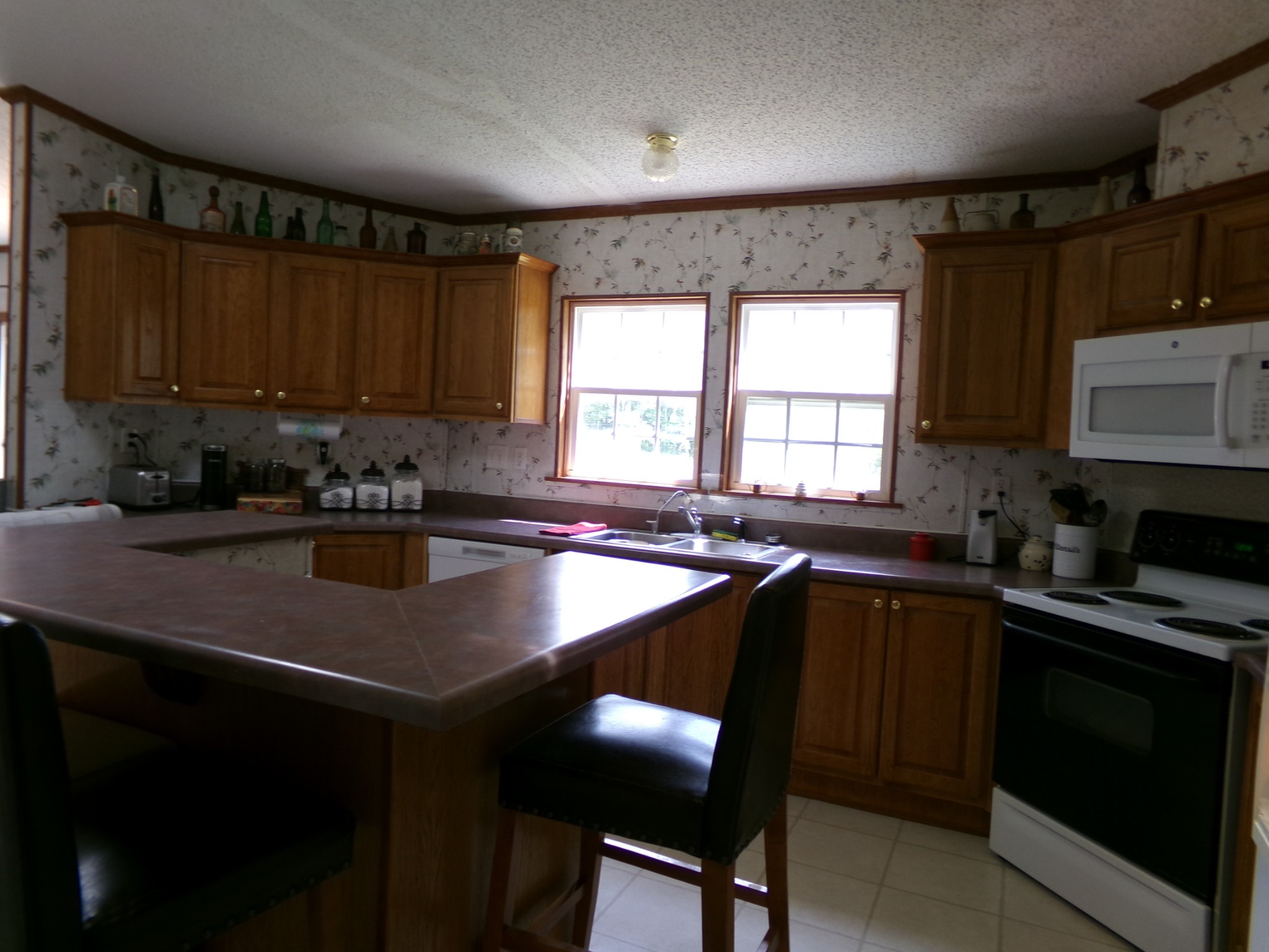 258 Paul Thompson Road Bethpage, TN 37022 - Photo 10 of 23 a kitchen with a sink a stove a microwave cabinets and a dining table