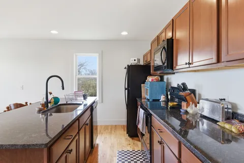 a kitchen with refrigerator a stove and a sink