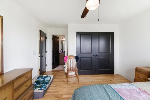 a bedroom with a bed and a chandelier