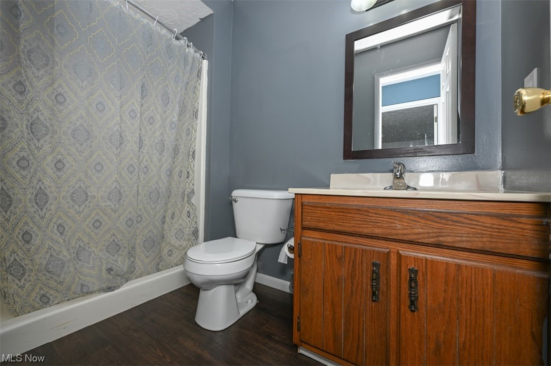 3368 Erhart Road Litchfield, OH 44253 - Photo 14 of 35 Bathroom featuring dark hardwood flooring, vanity, and mirror